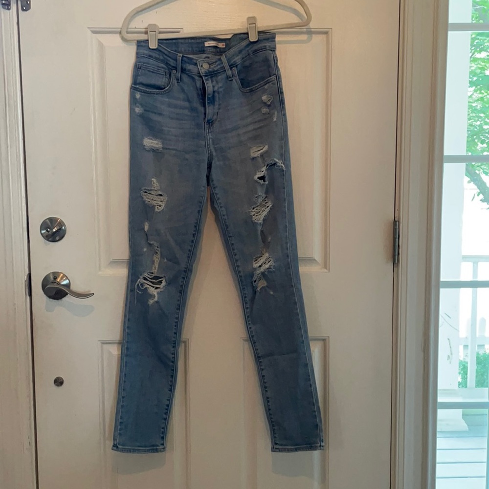 Levi medium wash jeans with holes/ size 28